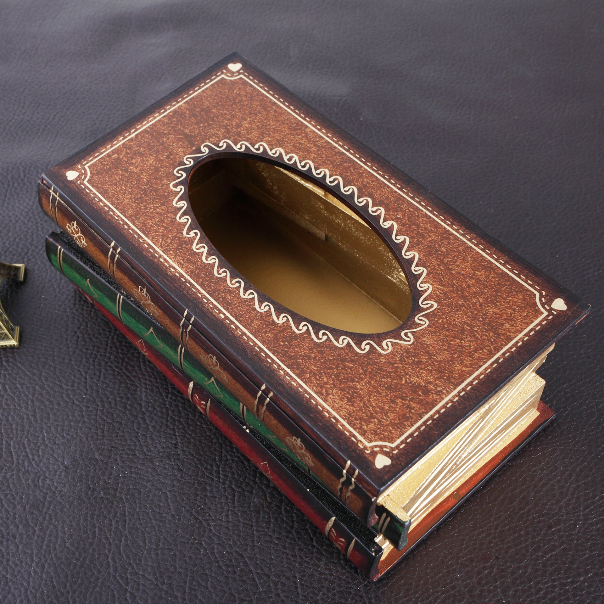 Vintage wooden book-style tissue box cover with embossed leather-look design on desk
