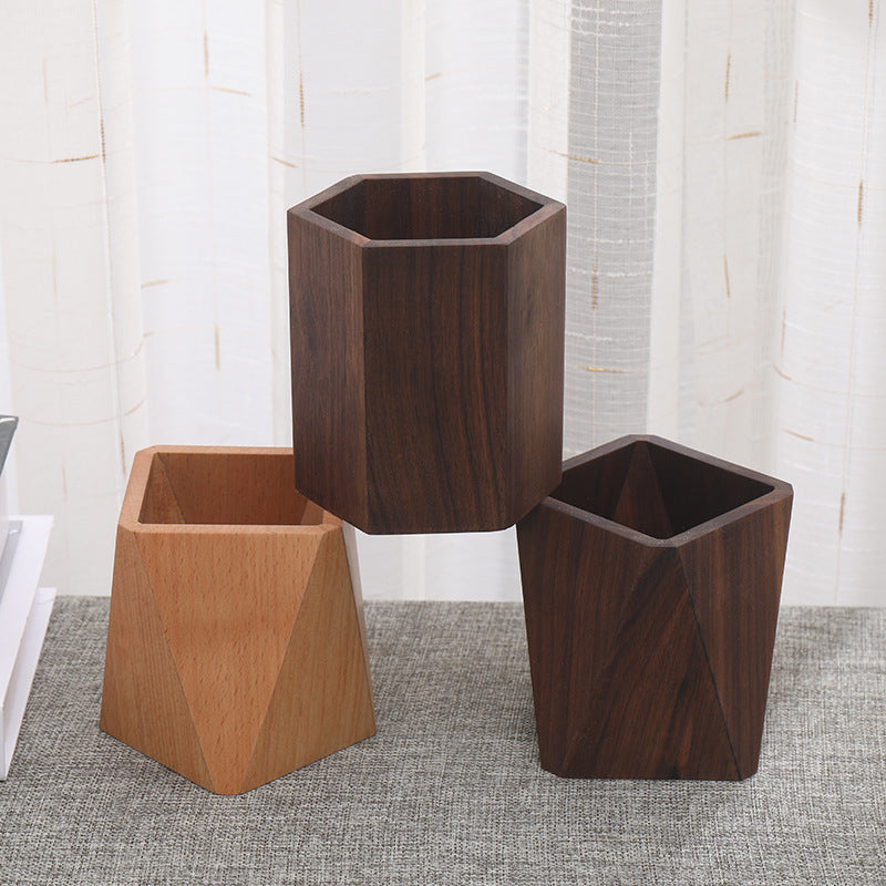 Three wooden pen holders in hexagon and square shapes displayed on a home decor shelf