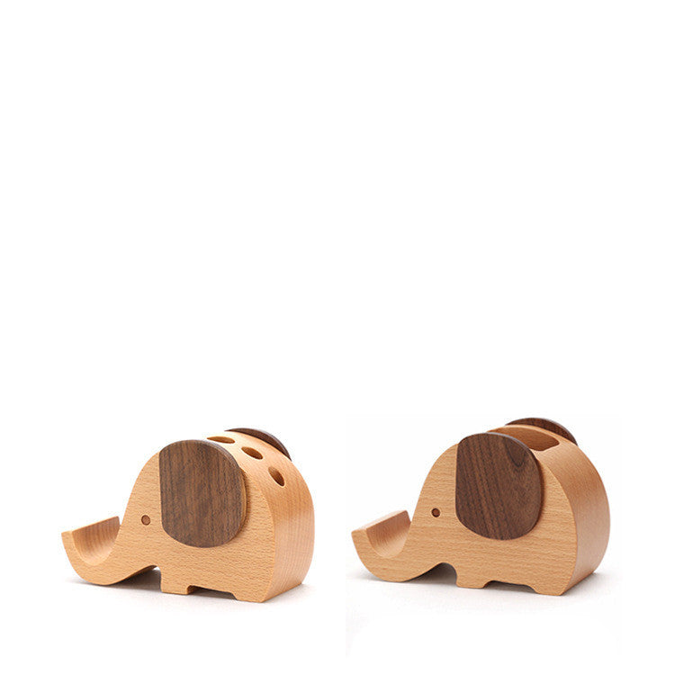 Close-up of wooden elephant pen holders in light beech and dark walnut finishes