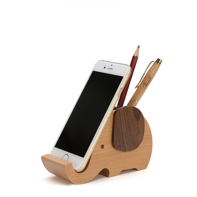 Wooden elephant-shaped pen holder and phone stand holding a smartphone and pen