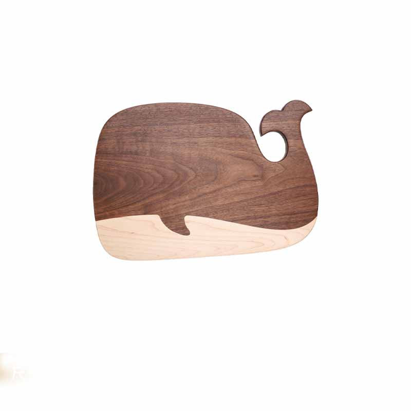 Small black walnut whale-shaped cutting board with maple tail accent