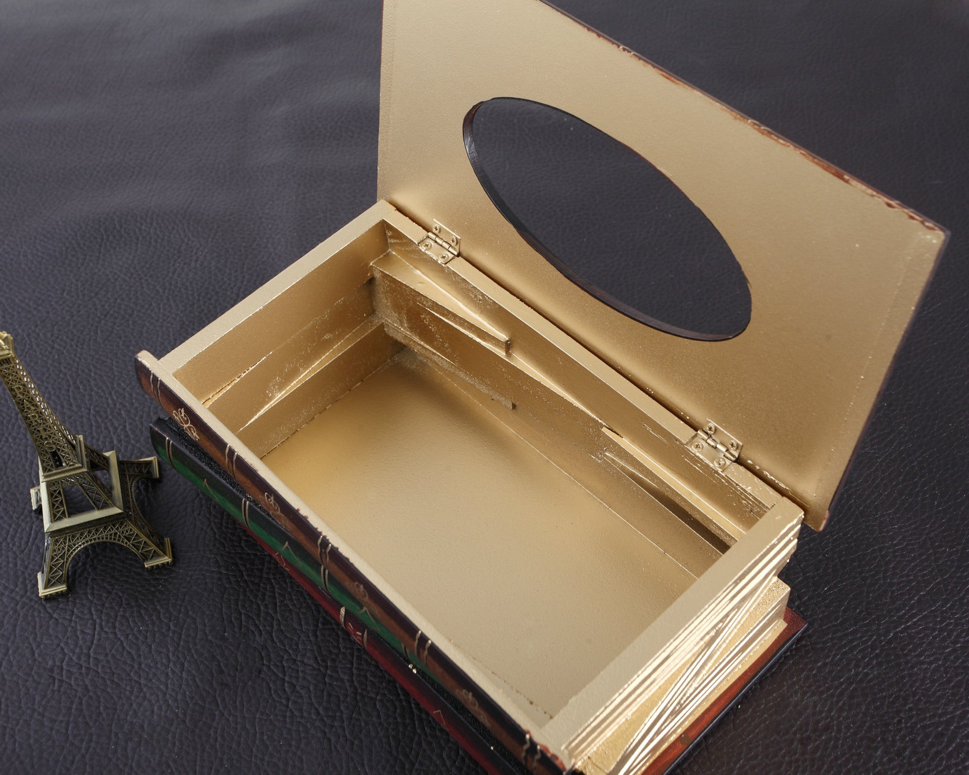 Open view of the book tissue box cover showing hinged lid and interior storage space