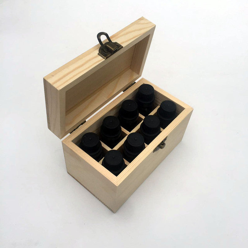 Wooden essential oil storage box fully filled with eight dark glass essential oil bottles neatly organized in compartments
