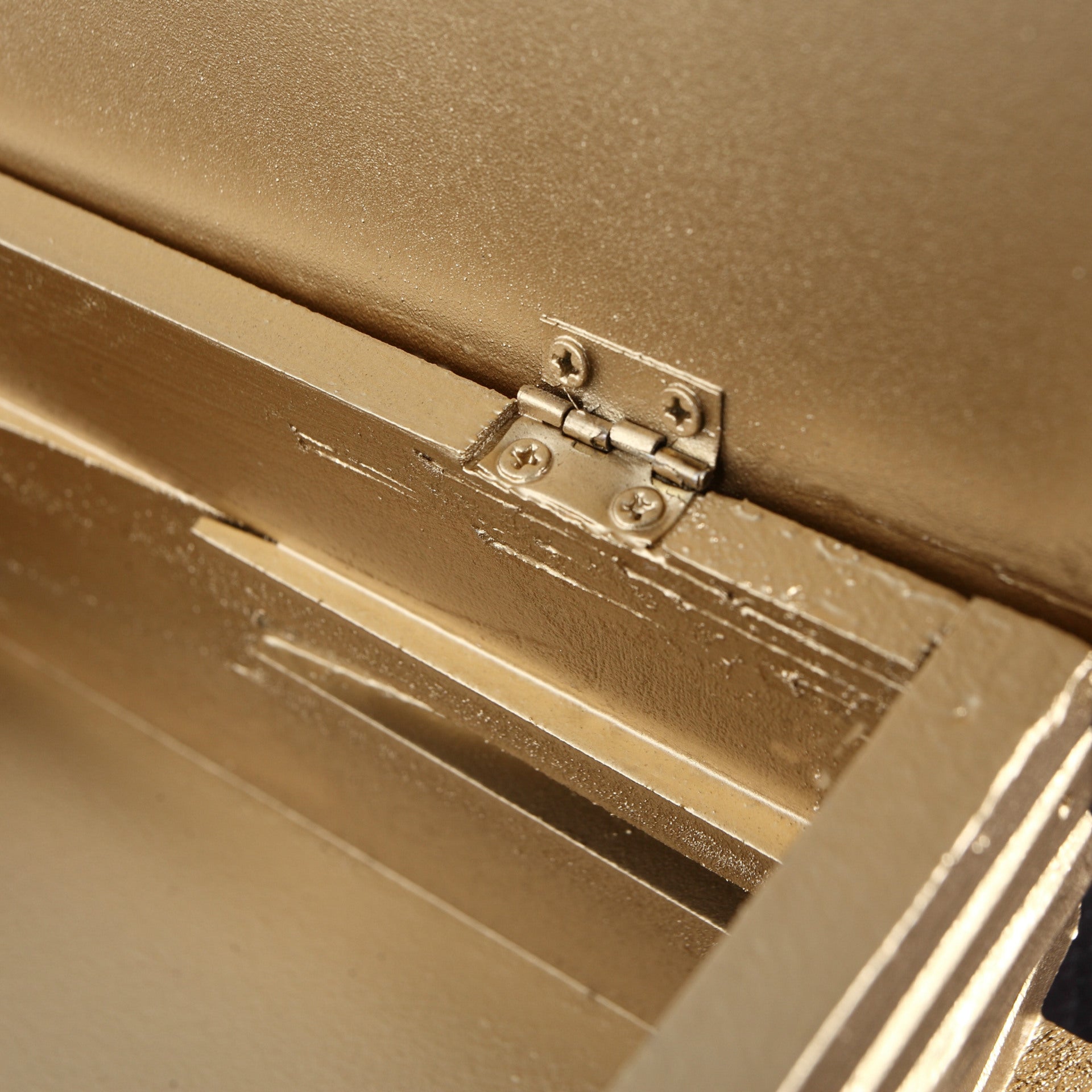 Close-up of the sturdy metal hinge on the wooden book tissue box cover